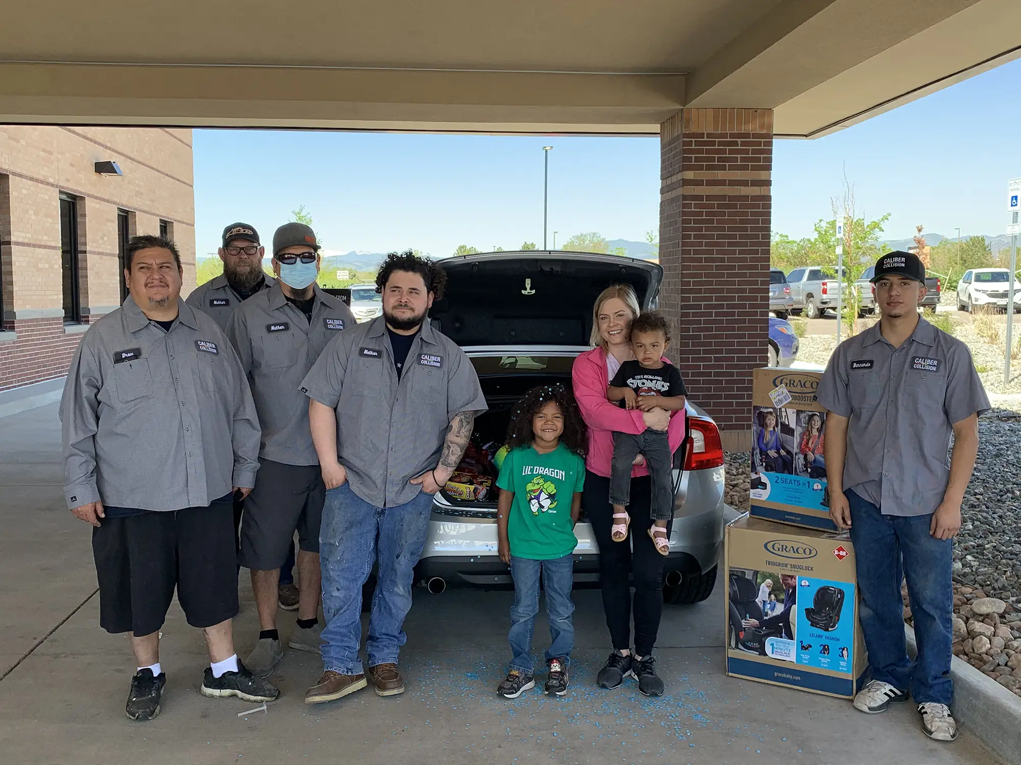 A deserving family and the Collision Team behind the vehicle restoration work at an NABC Recycled Rides giveaway event.